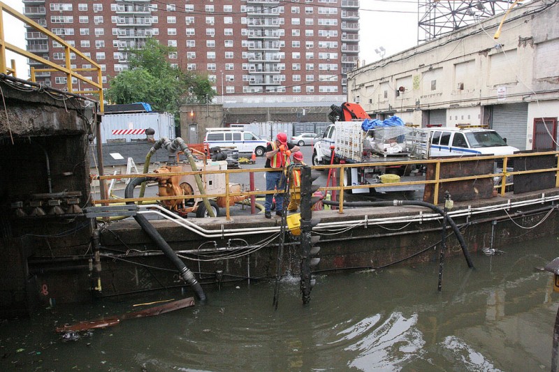 Workers pump water out of 148th Street / Lenox Ave. (Courtesy MTA / George Von Dolln)