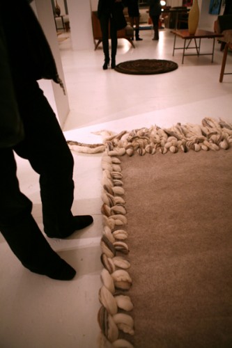"Wayward" is a handfelted rug with an enormously braided border. 