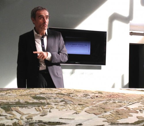Exhibition curator Pedro Azara in front of a model of Baghdad. 