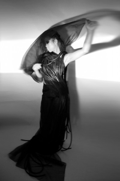 Eric Kahn's Black Evening Dress is made from continuous strands of silk synthetic rubber cord.
