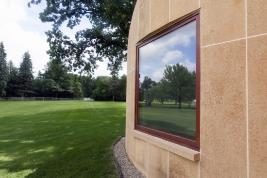 A window in the Winton Guest House reflects the surroundings (Photo by Olga Ivanova, courtesy University of St. Thomas)