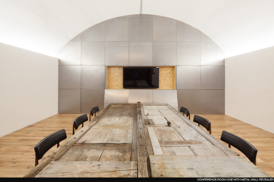 The conference room in AF's existing offices, in which reclaimed doors are used as tables (Courtesy Design Haus Liberty)