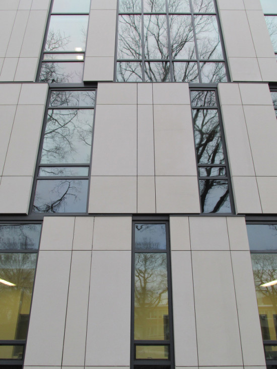 The primary facade features a checkerboard pattern of concrete panels and glazing. (Courtesy Urbahn Architects)
