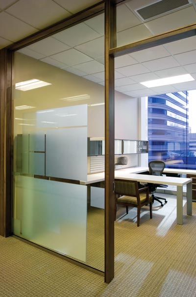 Glazed office fronts admit light to the office interior.