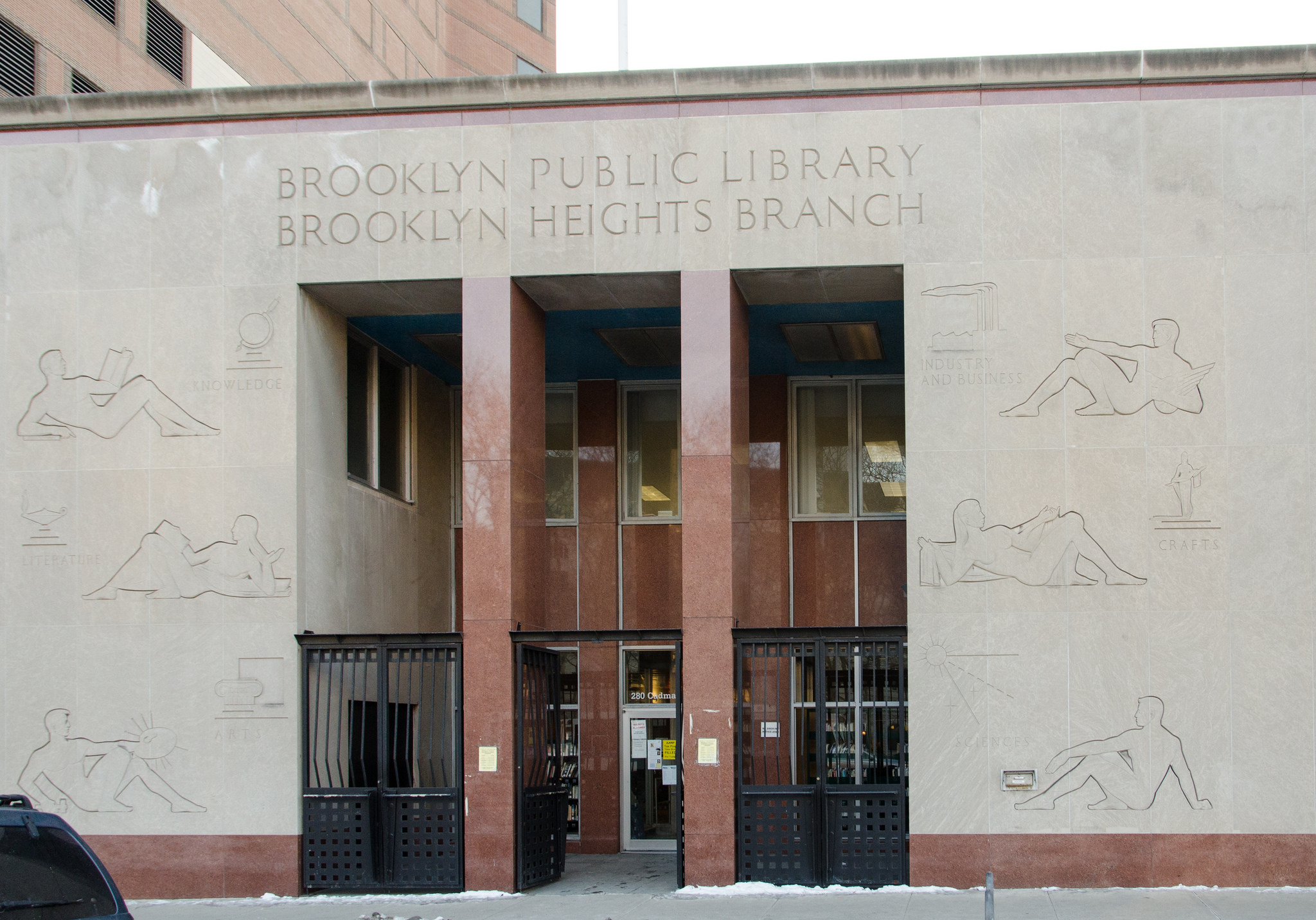 The Brooklyn Heights Library main entrance sports six bas reliefs on its limestone facade. (Ehblake / Wikimedia Commons)