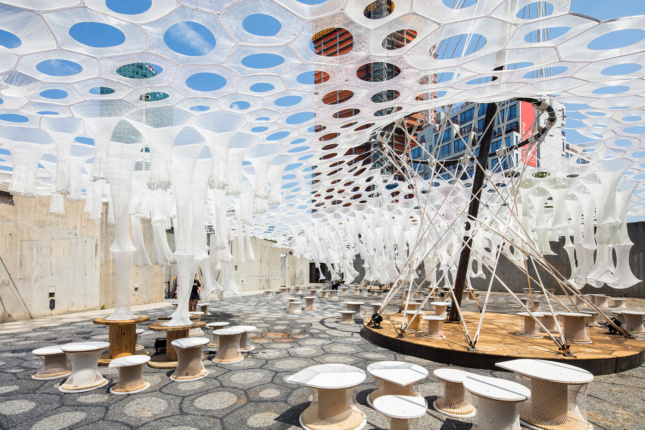 Photo of the MoMA PS1 courtyard with a spun canopy