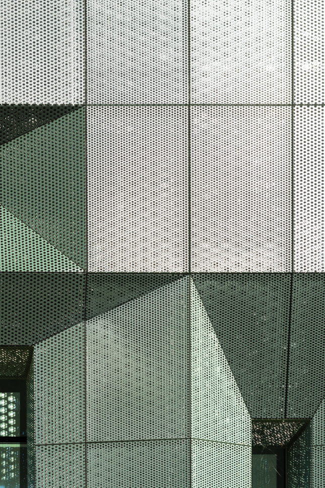 A detail of the perforated green metal screen