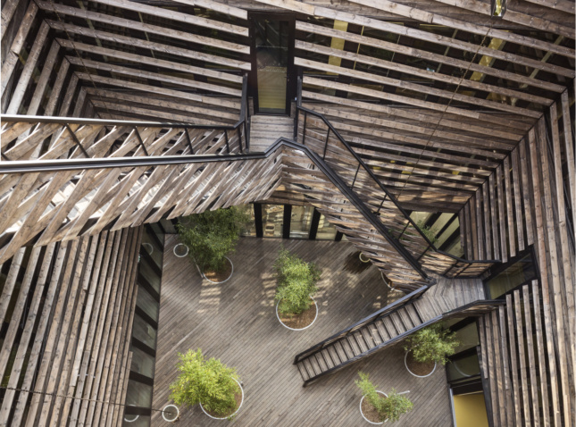 The courtyard is lined with timber sunscreen composed of four-inch thick horizontal members set at a slight inclination