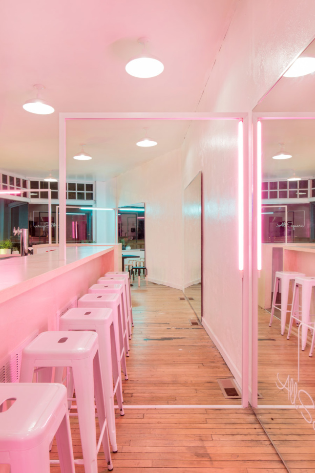 The bar area bathed in pink light.