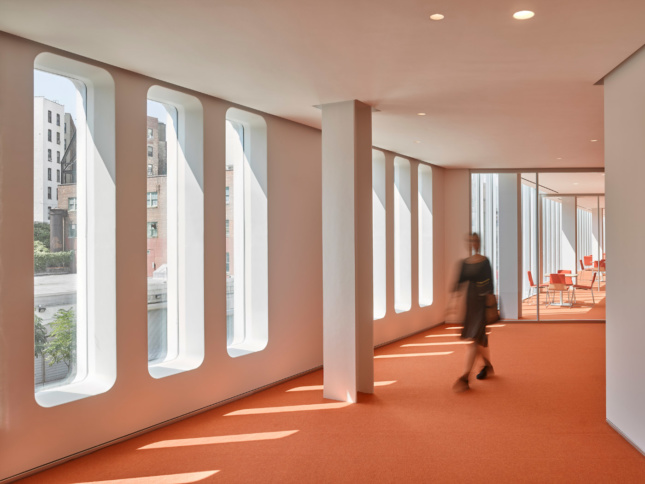 Curvy windows and bright orange carpeting lends some spaces in the Forum a throw-back feel. 