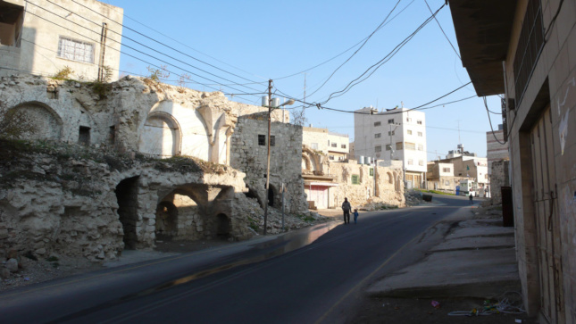 The remnants of Palestinian homes that were bulldozed in 2004 to create the road known as "Worshippers Way," which connects the Israeli settlement Kiryat Arba to religious sites in the Old City of Hebron. These houses and other similar buildings were the subject of a legal battle argued in the Israeli High Court, brought by Palestinian landowners and the city, that sought to have the houses protected as examples of Mamluk-Ottoman architecture.