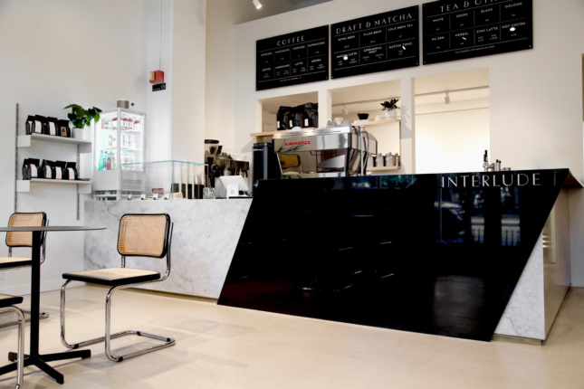 The owner mixed midcentury modern style with the simplicity of Danish design by bringing in pieces like Marcel Breuer’s Cesca Chairs and the Neu Table by HAY. The focal point of the space is the dramatic L-shaped cafe counter with marble and granite from Arena Stone Products in New Jersey.