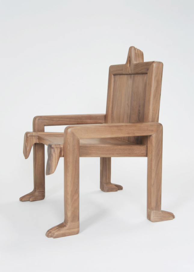 Crawl Chair, a waxed-walnut seat adorned with carved hands and feet from the gender-neutral collection of children's furniture, Fictional Furniture.