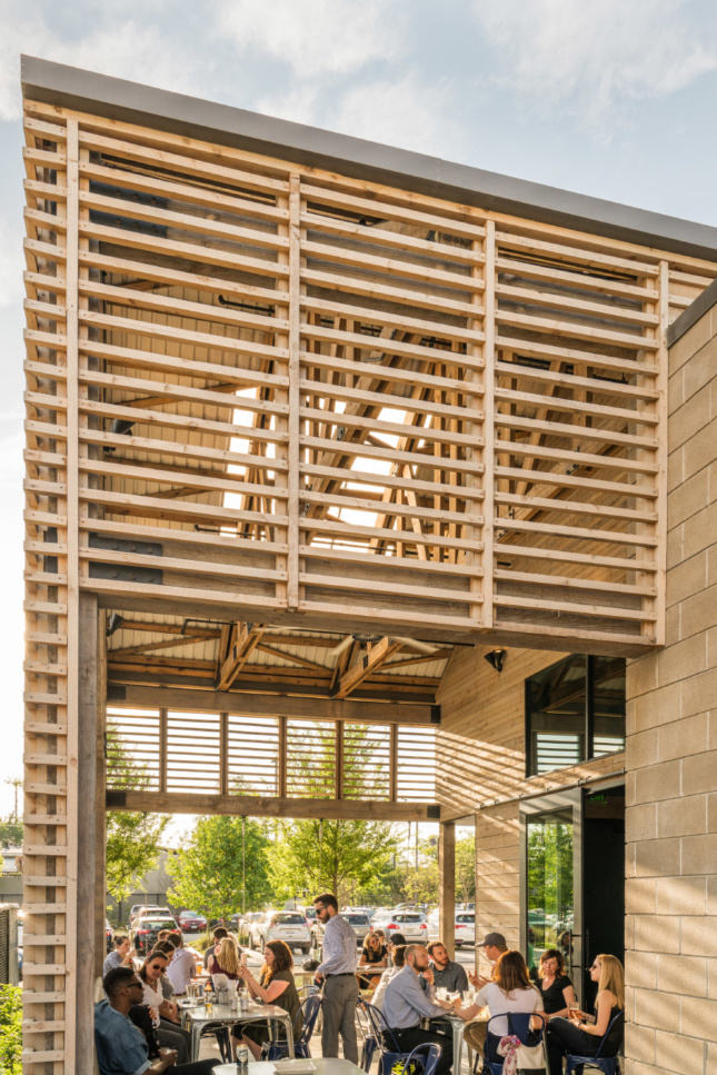 Louvers provide ventilation on the porch while revealing the unfinished wood trusses within.