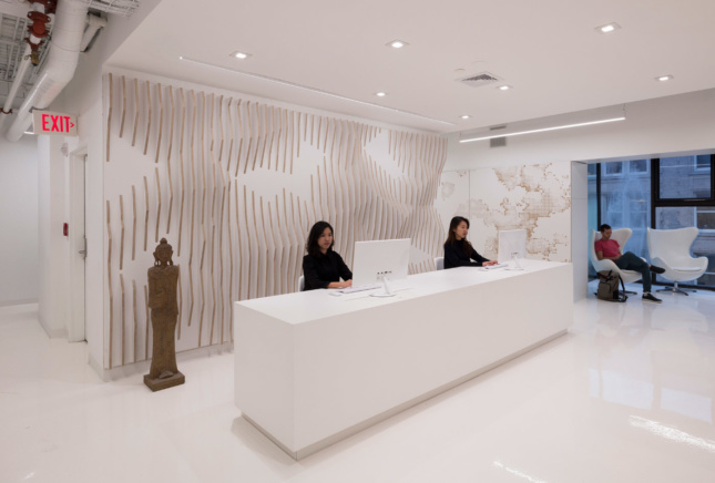 The MINT reception area features an undulating wall cut from plywood.