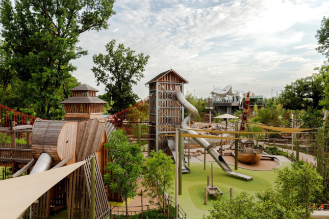 Photo of a playground with fake turf and wooden towers