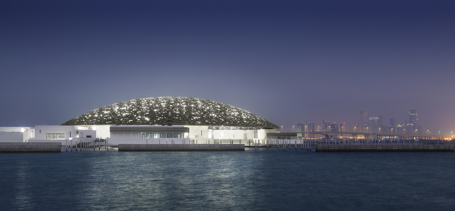 Exterior night view of the Louvre Abu Dhabi