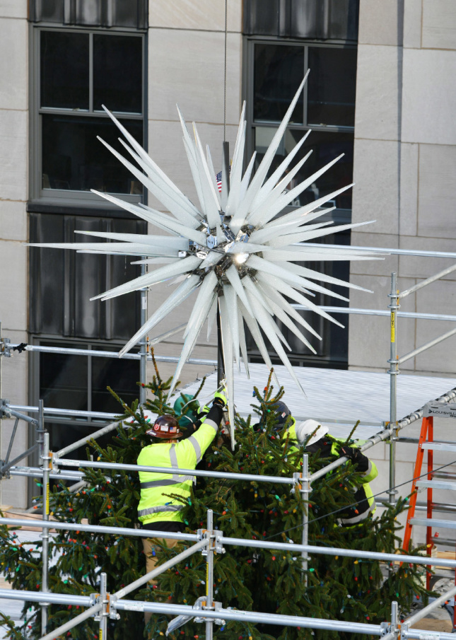 The star being fastened to the Rockefeller Center Christmas Tree.
