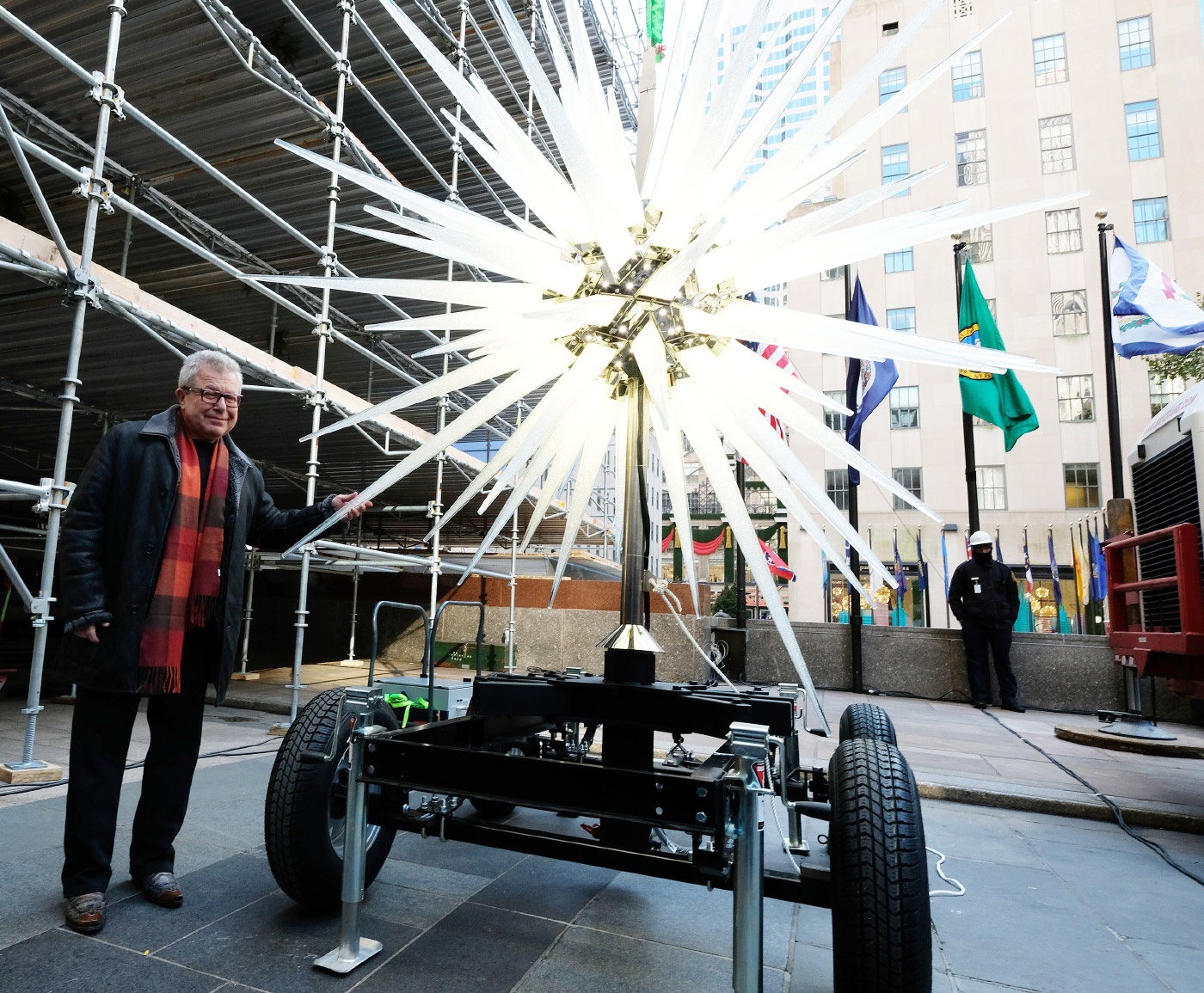 Photo of Daniel Libeskind posing in front of the Rockefeller Center Swarovski Christmas tree star