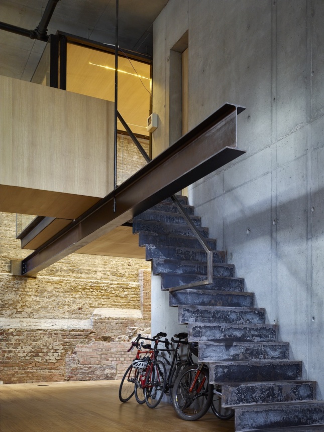 Photo of a staircase leading out of a rustic stone basement