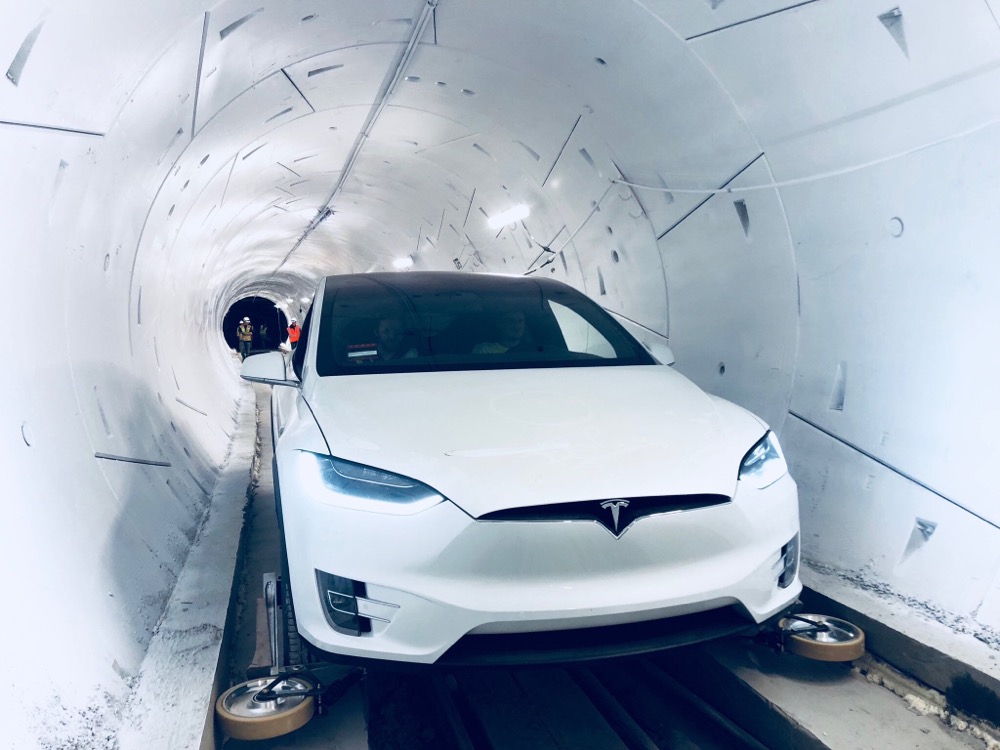 Photo of Tesla car driving through a Boring Company tunnel