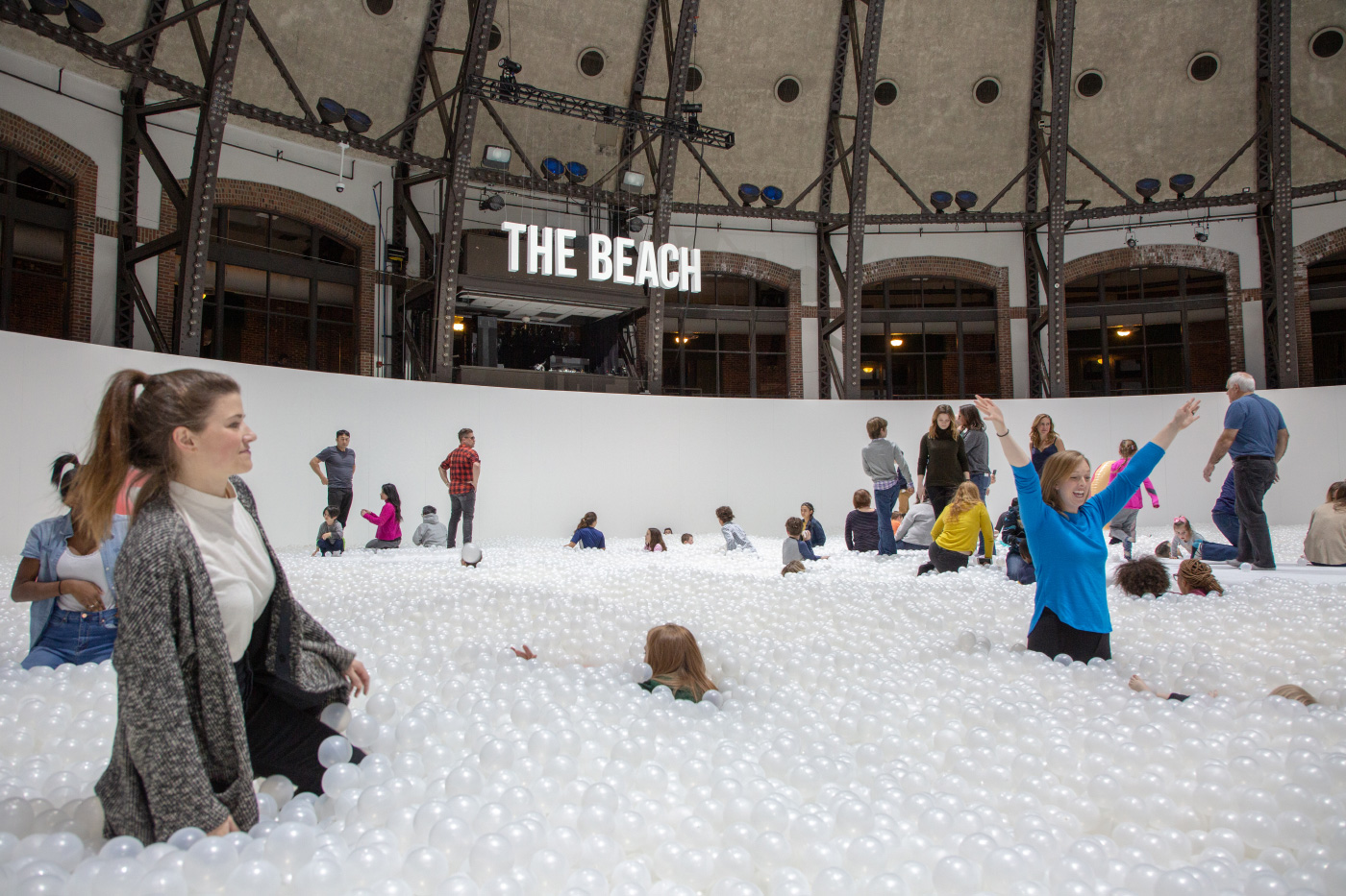 Photo of a white ball pit and visitors
