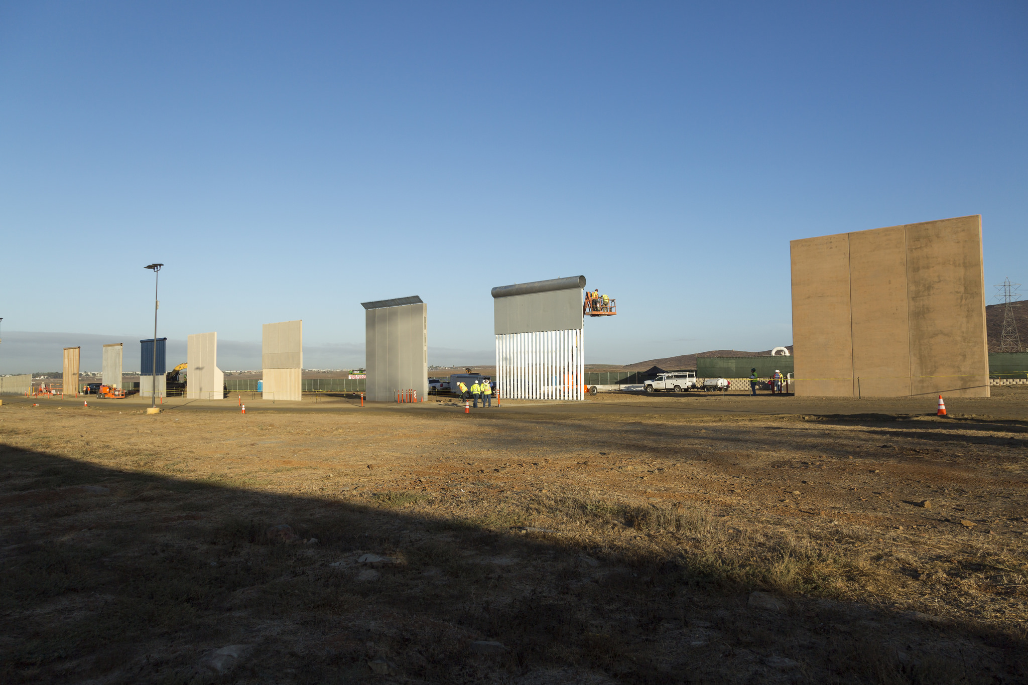 Photo of eight border wall prototypes