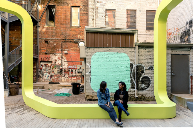 Photo of two women sitting on City Thread talking