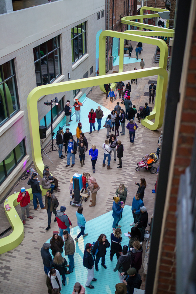 Aerial photo of alley with people interacting with City Thread installation