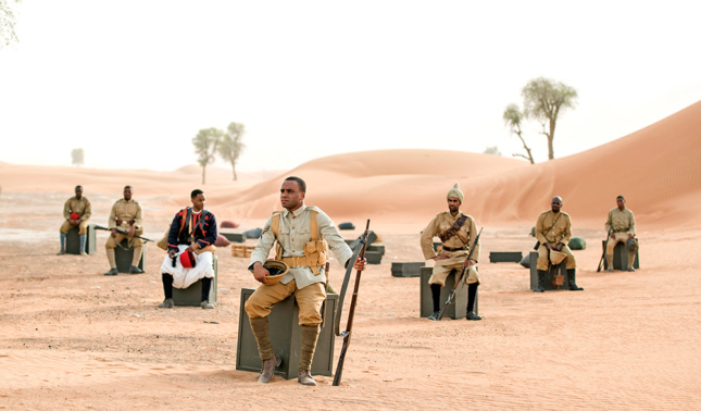 Photo of soldiers sitting in a desert