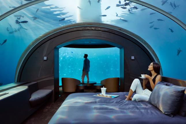 Photo of two people in an underwater room