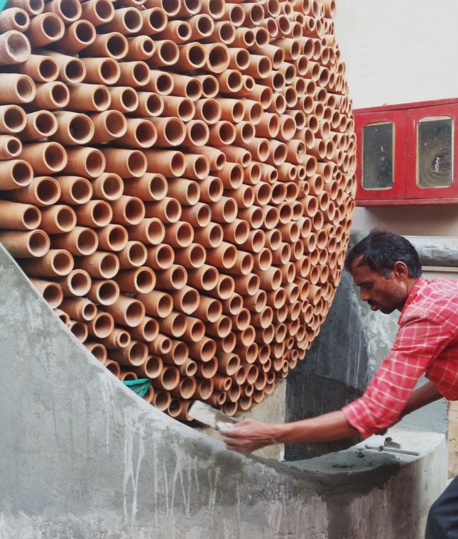 Photo of terra-cotta tubes being put together