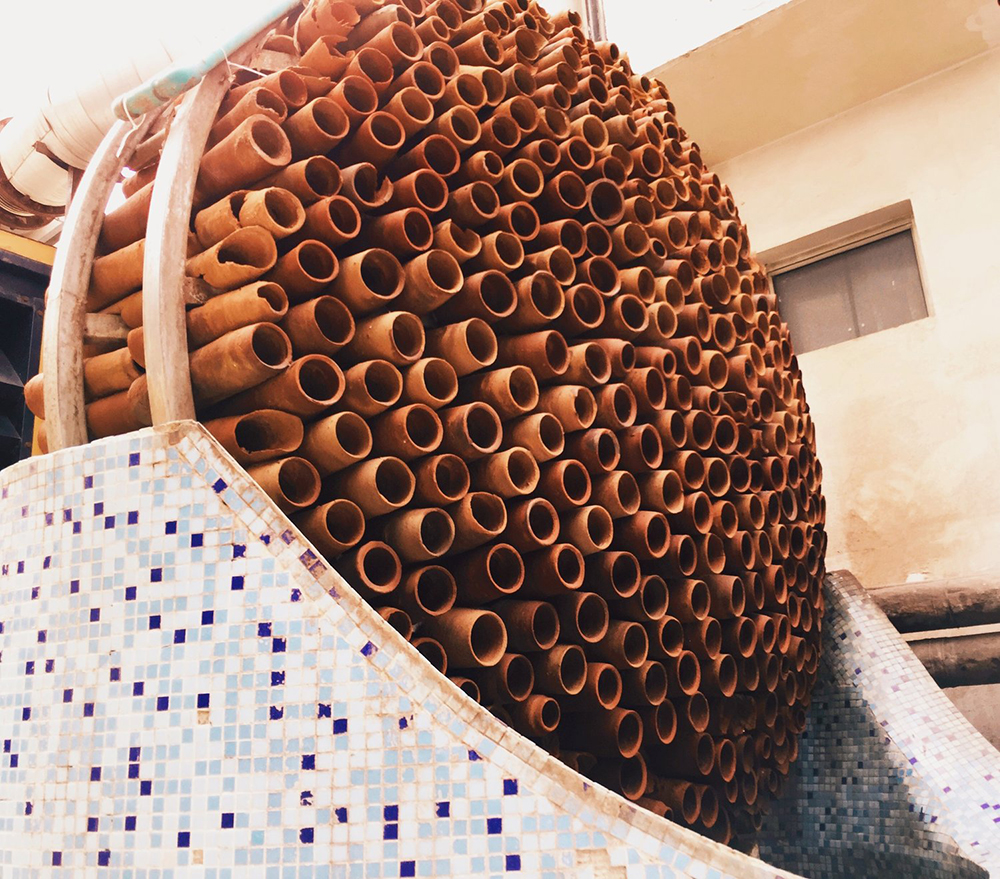 Photo of Beehive installation of many terra-cotta tubes