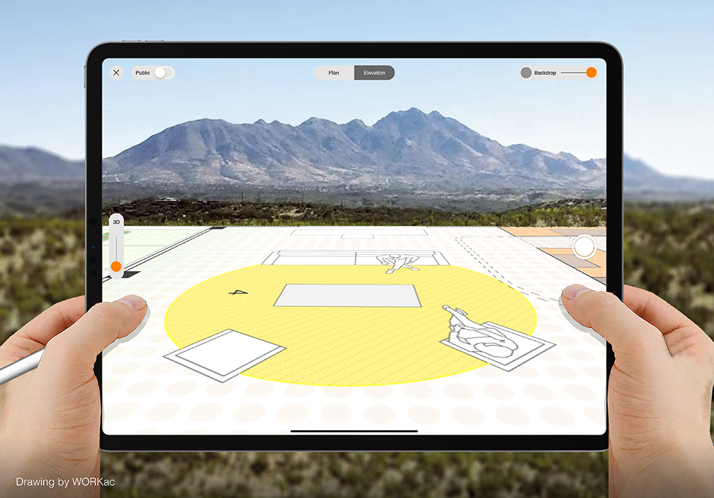 Hands hold up an iPad Pro in front of a mountain seen where a scale CAD drawing is projected.