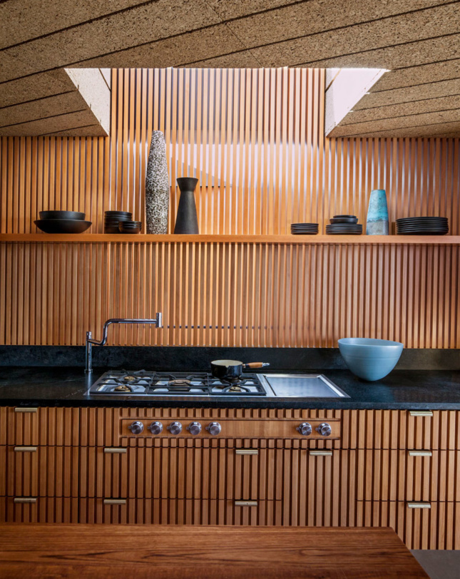 Photo of a kitchen wrapped in vertical wood dowels