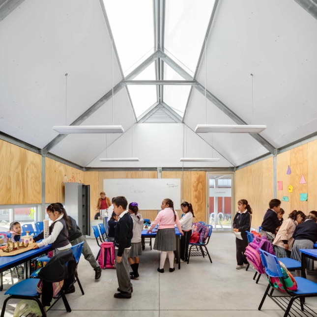Photo of students working in a modular unit with solid walls and a skylight
