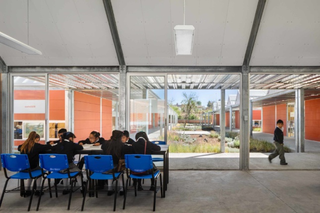 Photo of kids inside a modular unit with large glass window walls