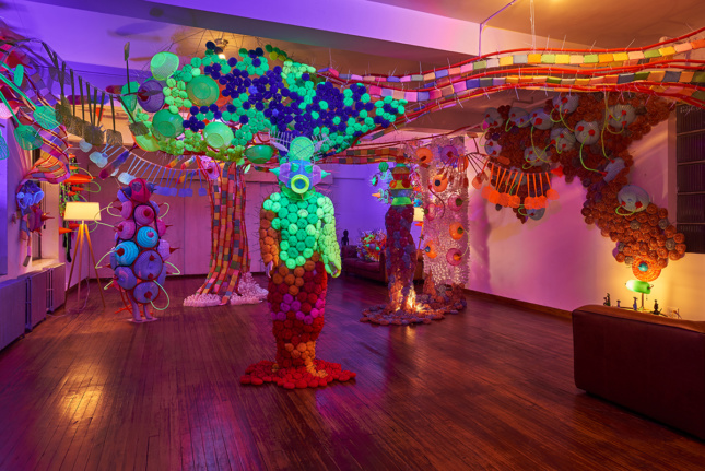Photo of a room filled with sculptures made of colorful cheap plastic goods