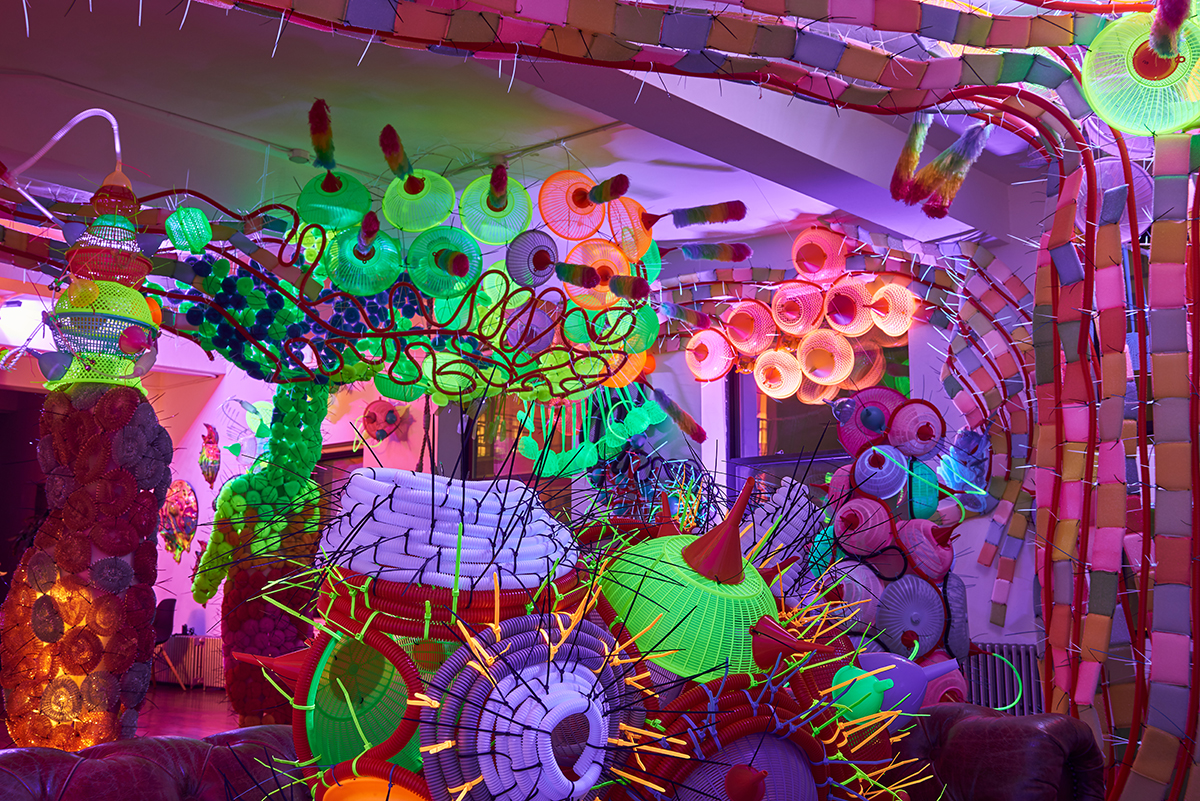 Photo of a room filled with sculptures made of colorful cheap plastic goods
