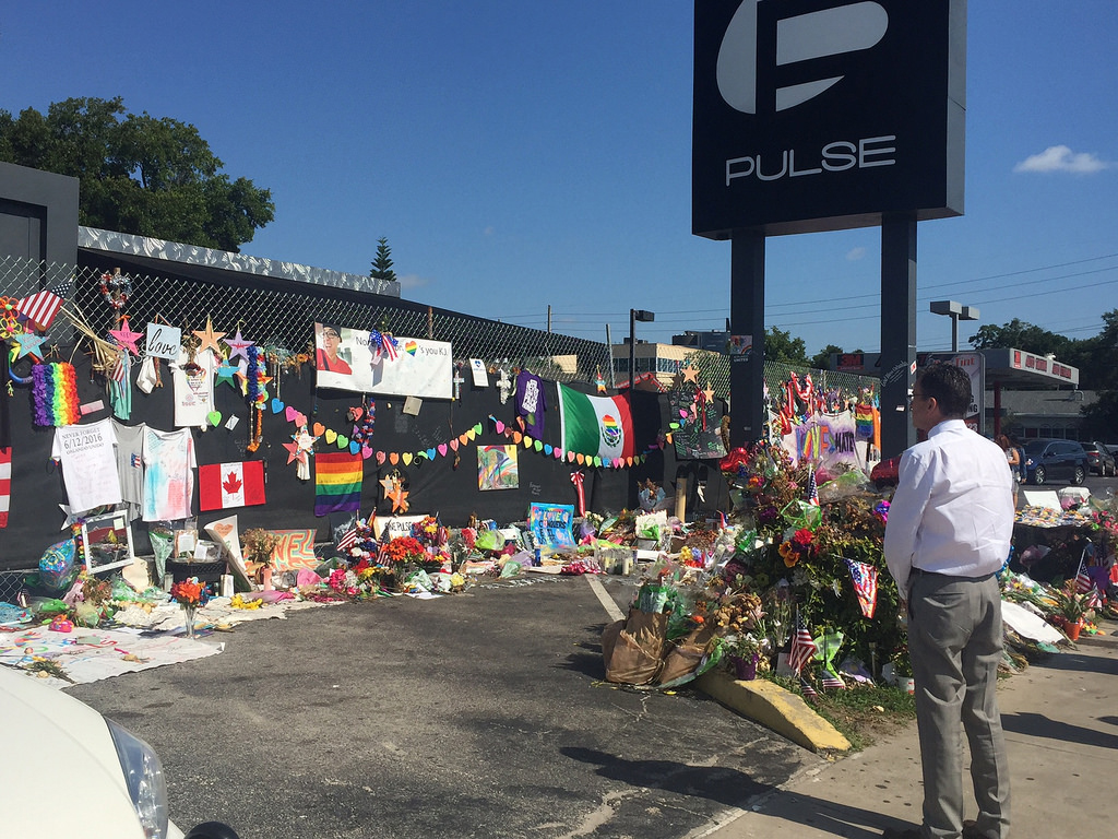 Photo of Florida Governor looking at Pulse nightclub memorial