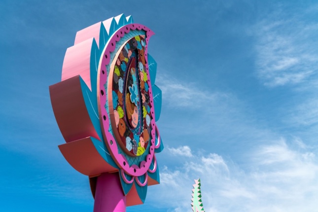 Photo of a brightly colored large sign in the shape of a paisley flower