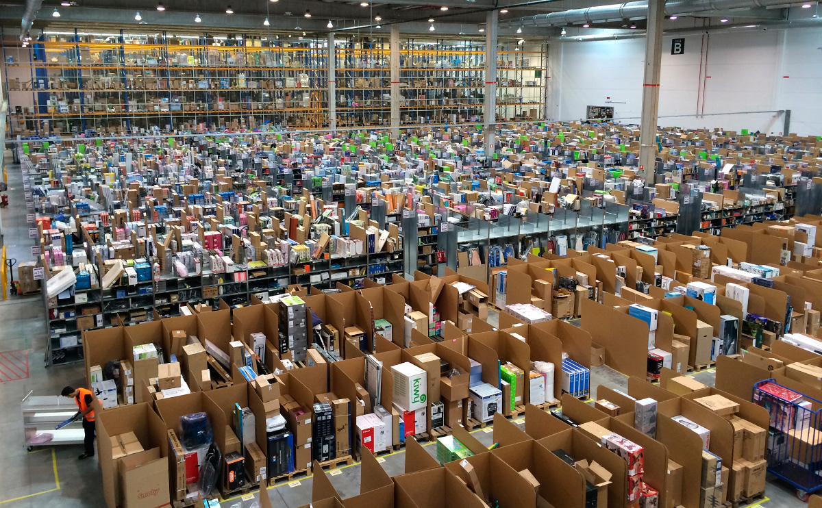 Photo of rows upon rows of cardboard boxes being packed in a warehouse
