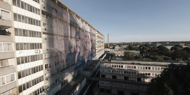 Rendering of a film projected on the side of a housing estate