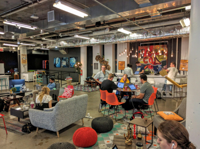 Photo of the interior photo of an industrial-style coworking space with pendant lights