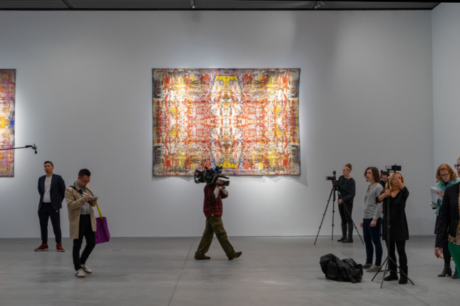 A tapestry in a white gallery