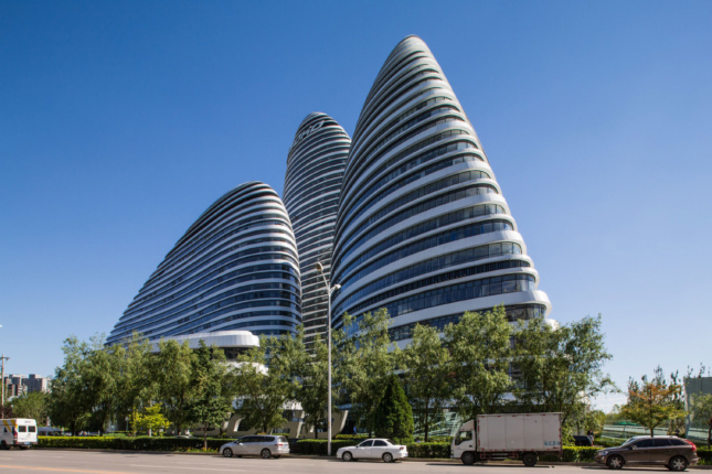 A photo of three rounded, striated office towers against each other