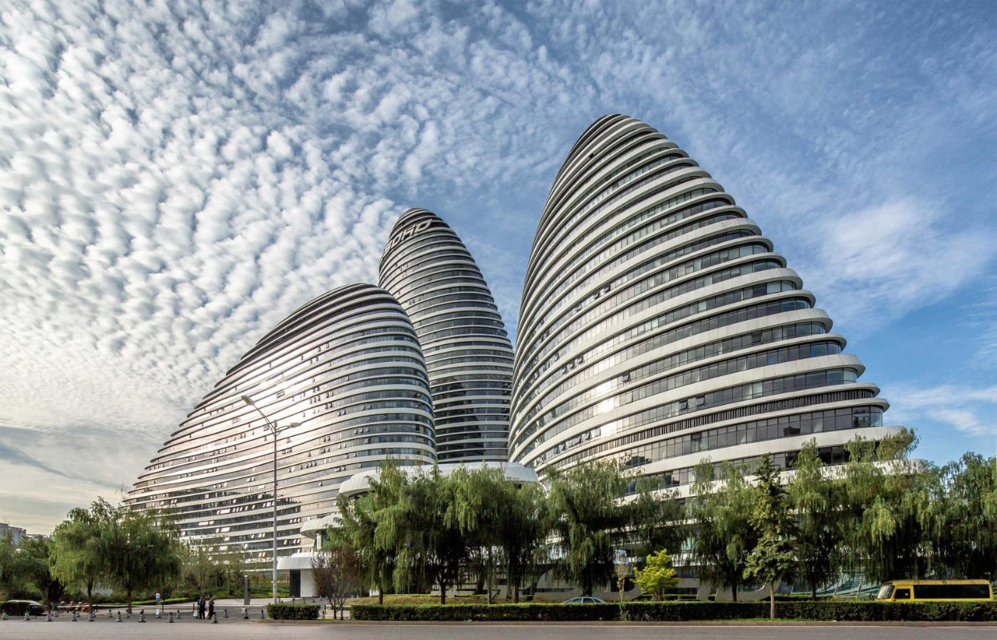 Photo of three rounded, pebble-shaped office towers against a clear sky