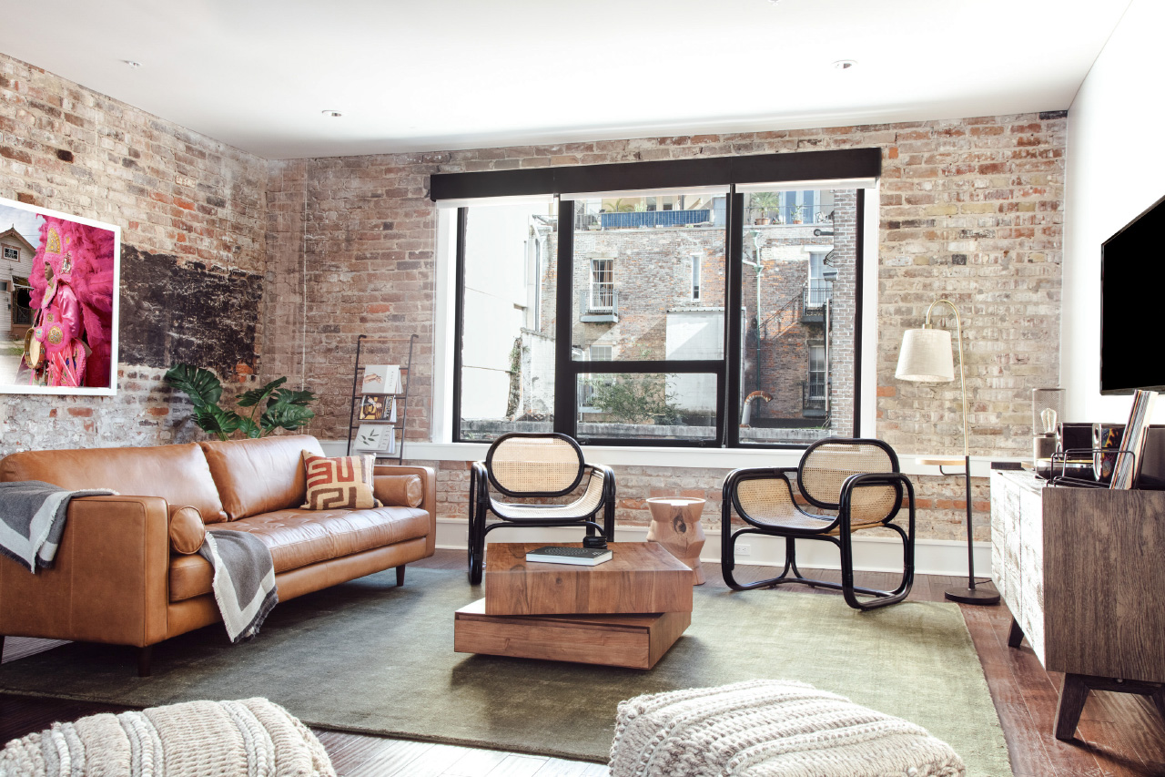 Photo of A living room with brick walls and rattan chairs