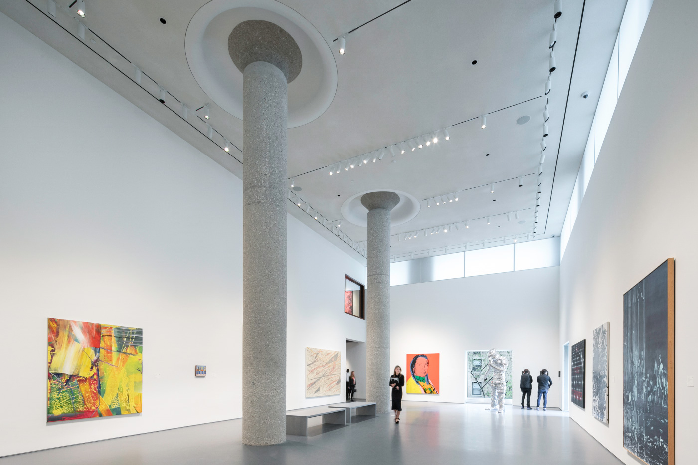 Photo of a double-height gallery space with concrete columns in the center