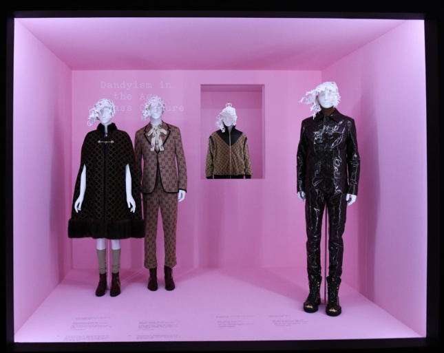 Photo of a pink box gallery with three mannequins clad in black costumes
